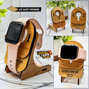 May include: A wooden stand for charging an Apple Watch. The stand is made of 1/8 inch plywood and has the text "Charge Me Up" engraved on it. The stand is shown with a pink Apple Watch band.