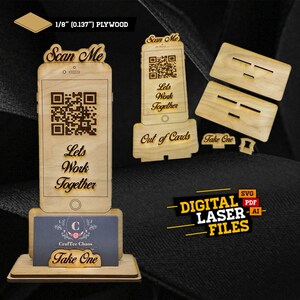 Op de afbeelding: Een houten telefoonstandaard van 1/8 inch multiplex, met een QR-code en de tekst "Scan Me" en "Let's Work Together". De standaard heeft ook een visitekaartjeshouder met de tekst "Take One".