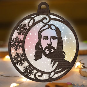 May include: A wooden Christmas ornament featuring a silhouette of Jesus with a beard and long hair. The ornament is decorated with snowflakes and stars on a light blue and pink background.
