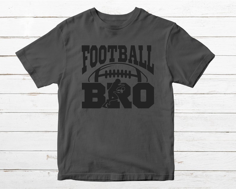 May include: A dark gray t-shirt with the text "FOOTBALL BRO" in black lettering. A football and a football player are depicted in the design.