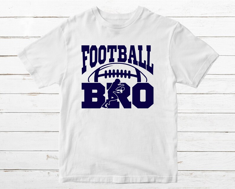 May include: White t-shirt with a navy blue graphic that says "FOOTBALL BRO" with a football and a football player silhouette.