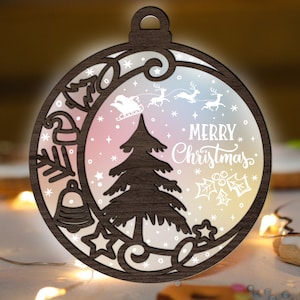 May include: A wooden Christmas bauble ornament with a white background and a rainbow gradient. The ornament features a cut-out design of a Christmas tree, reindeer, and the text "Merry Christmas".
