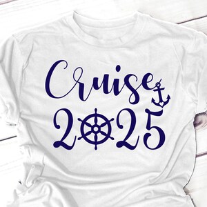 May include: White t-shirt with a navy blue graphic that says "Cruise 2025" with a ship's wheel and anchor.