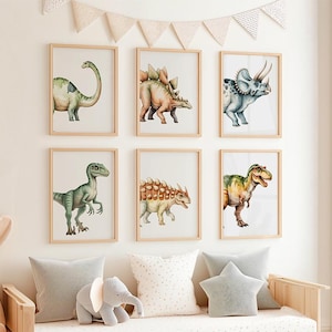 May include: Six framed dinosaur art prints. Each print features a different dinosaur illustration in watercolor style. The dinosaurs are in shades of green, brown, and blue. The frames are light wood, and the overall theme is a nursery or children's room.