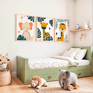 May include: A children's bedroom scene with three framed animal prints: an elephant, a giraffe, and a lion. The room includes a green bed, a plush lion, an elephant toy, and a wooden shelf with decorative items. The overall theme is a playful and colourful nursery.