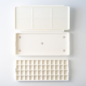 Pode incluir: Paleta de pintura de plástico branco com 24 cavidades. A paleta tem uma tampa com uma bandeja separada para misturar tinta.