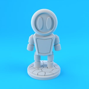 Puede incluir: Una figurita de robot blanco con una cabeza redonda y dos ojos grandes. El robot está de pie sobre una base blanca con una superficie agrietada.