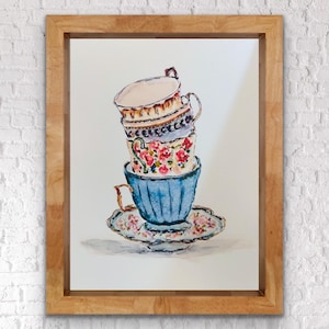 May include: A stack of four vintage teacups with floral and geometric patterns. The cups are stacked on a saucer with a floral design. The cups are painted in shades of blue, pink, white, and gold.