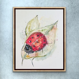 May include: Watercolor painting of a ladybug on a green leaf. The ladybug is red with black spots and has a black head. The leaf is green with a white background.