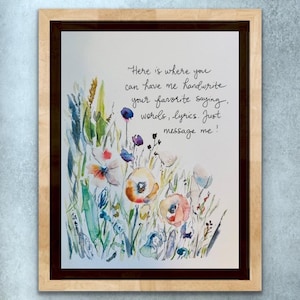 May include: A framed watercolour print with a floral design in shades of orange, pink, and blue. The artwork includes handwritten text: "Here is where you can have me handwrite your favourite saying, words, lyrics. Just message me!"