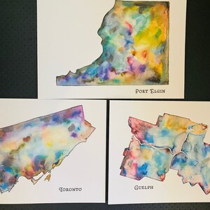 K&ouml;nnte beinhalten: Drei Aquarellbilder von Stadtumrissen. Die Umrisse sind mit bunten Aquarell-Waschungen gef&uuml;llt. Die St&auml;dte sind mit "Toronto", "Guelph" und "Port Elgin" beschriftet.