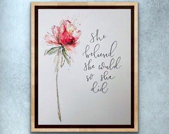 May include: A watercolor painting of a pink flower with a quote that reads "She believed she could so she did."