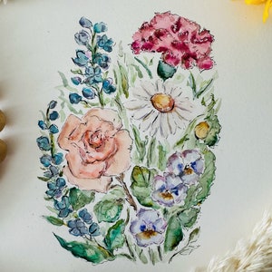 May include: Watercolor painting of a bouquet of flowers, including a pink carnation, a peach rose, a white daisy, and purple pansies. The flowers are surrounded by green leaves and stems.