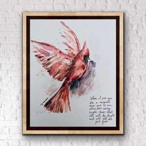 May include: Watercolor painting of a red cardinal bird in flight with gold accents. The painting includes a quote: "When I see you it's a magical sign and I am reminded every single time, that all will be alright and all will be just fine."