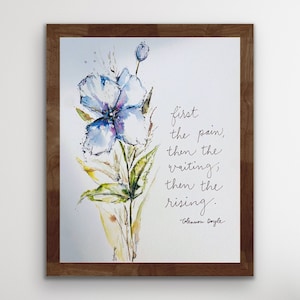May include: A framed watercolor painting of a blue flower with a quote by Glennon Doyle: "first the pain, then the waiting, then the rising."