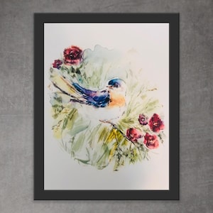 May include: Watercolor painting of a bird with blue, orange, and white feathers, perched amidst green foliage and red flowers. The artwork is framed in a black border, creating a visually appealing piece of art.