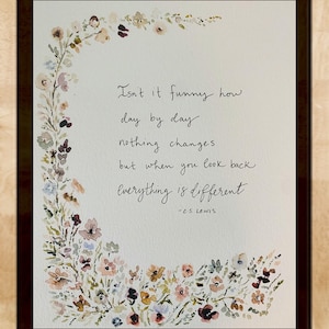 May include: A watercolour painting of a floral wreath with a quote by C.S. Lewis that reads: "Isn't it funny how day by day nothing changes but when you look back everything is different -C.S. Lewis"
