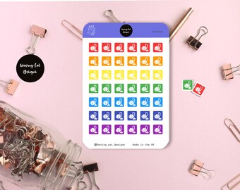 May include: A sheet of rainbow colored stickers featuring a white vacuum cleaner icon. The stickers are arranged in a grid pattern and are perfect for adding a touch of fun to your planner or journal.