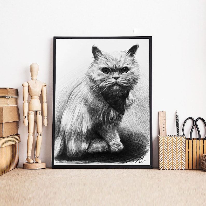 May include: Black and white pencil drawing of a fluffy cat with a serious expression. The cat is sitting with its head tilted slightly to the side. The drawing is framed in a black frame.