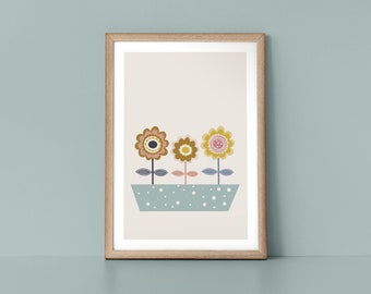 May include: A framed print of three stylized flowers in a pot. The flowers are yellow, pink, and brown with blue and green stems. The pot is light blue with white polka dots.