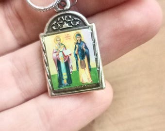 Charm colgante de San Cipriano y Justina con oración contra el mal, protectores de la magia.