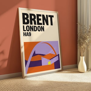 May include: A rectangular framed wall art print featuring the text BRENT LONDON HA9 in bold black letters on a cream background. Below the text is a stylized graphic illustration with geometric shapes in orange, purple, and dark blue colors.