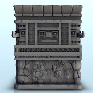 May include: A gray 3D printed model of a stone building with a roof and a face carved into the front. The building has a stone base and a decorative frieze.