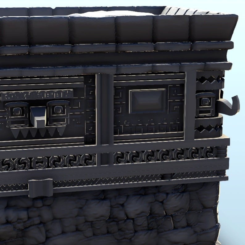 May include: A black stone building with intricate carvings and a window. The building has a textured surface and appears to be made of stone blocks.