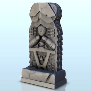 May include: A gray stone sculpture of a stylized human figure with a triangular symbol and geometric patterns. The sculpture is on a rectangular base.