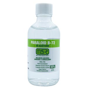 May include: A clear bottle of Paraloid B-72 in Acetone, with a white cap and a green and white label. The label includes text about the product's use for paint consolidation and ceramic repair. The bottle contains 2 fl oz (59 mL).