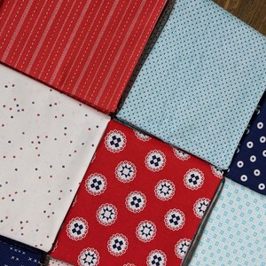 May include: A collection of eight fabric squares in red, blue, and white with various patterns, including polka dots, stripes, and geometric designs.