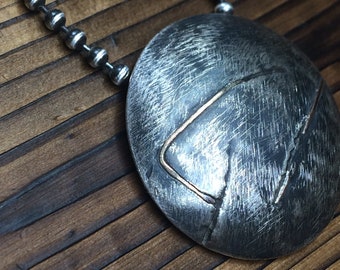 Silver domed pendant with gold wire