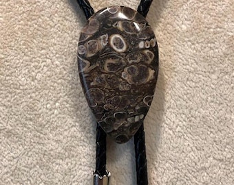 Turritella Stone Bolo Tie on Black Braided Leather Silver Tone Long Tips