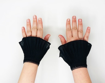 black pleated cuffs or collar, adjustable with button closure