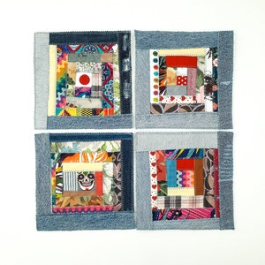 Peut inclure: Quatre dessous de verre carrés en tissu avec un motif patchwork. Chaque dessous de verre présente un carré central en patchwork entouré d'une bordure en jean. Le patchwork comprend divers tissus colorés, dont un avec un crâne.