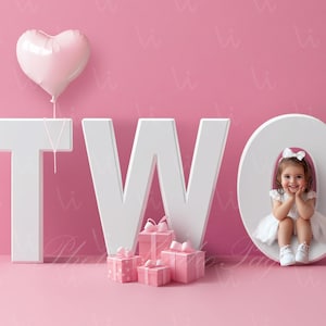 May include: A pink background with white letters spelling out "TWO". A young girl is sitting inside the "O" and smiling. There are pink gift boxes in front of the letters and a pink heart-shaped balloon above the "T".