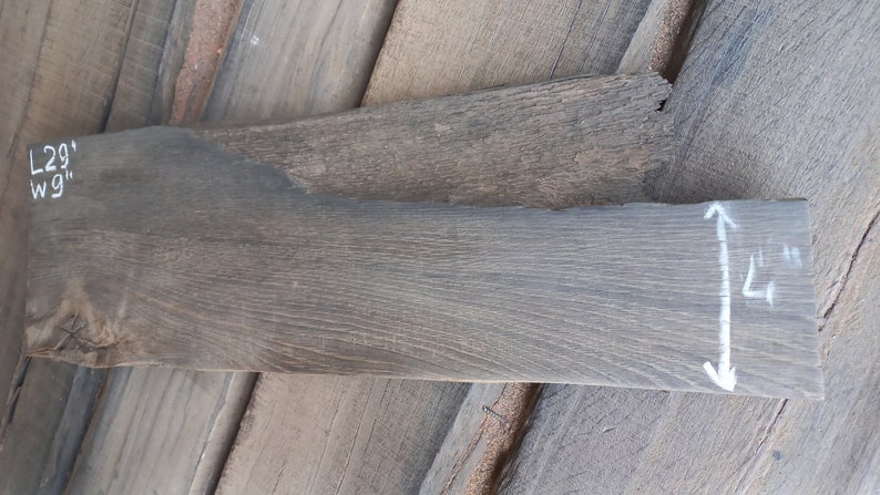May include: A piece of reclaimed wood with a gray finish. The wood is 29 inches long and 1 1/4 inches wide.