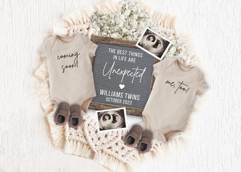 Pu&ograve; includere: Due body beige per neonati con il testo "coming soon!" e "me, too!" su di essi. Una lavagna di lettere grigia con il testo "The best things in life are unexpected. Williams Twins October 2023" e due immagini di ecografia.