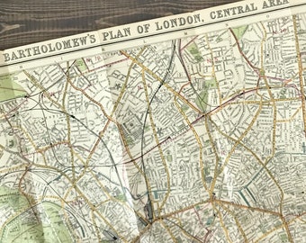 Antique map of London by Bartholomew. "1/2 Inch To The Mile" road map of Central London ca 1911. 24 x 36 inches, linen backed, comes folded.