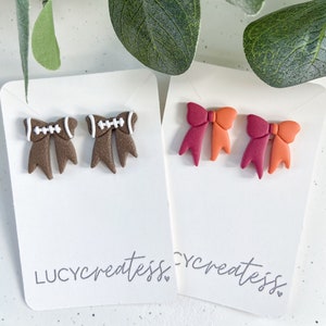 Football bow earrings . College football earrings . Team color studs . Football dangle earrings . Game day bow stud earrings . Football mom