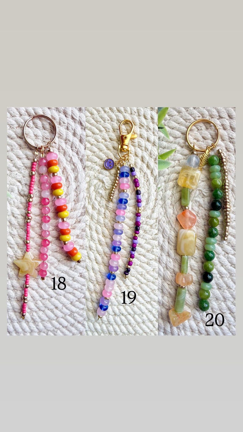 May include: Three beaded keychains with gold-colored hardware. One keychain features pink, yellow, and orange beads, and a star charm. Another has pink, blue, and purple beads. The third has green and yellow beads. Numbers 18, 19, and 20 are visible.
