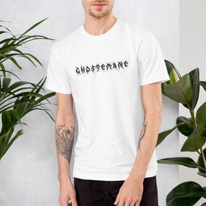 May include: White t-shirt with the text "GHOSTECRAINE" printed in black on the front.