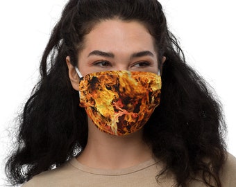 May include: A face mask with a fiery orange and yellow flame pattern. The mask is made of a soft, breathable fabric and is designed to be comfortable to wear.