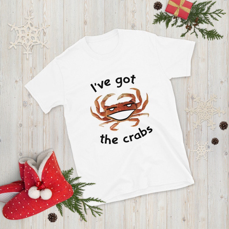 May include: White t-shirt with a cartoon crab and the text "I've got the crabs".