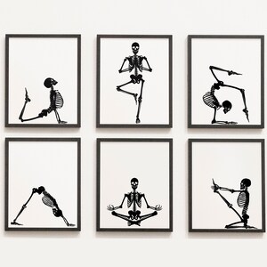 May include: Six framed art prints featuring black skeleton illustrations in various yoga poses against a white background. The prints are displayed in a grid, showcasing the skeleton figures in different asanas, including balancing, stretching, and seated positions.