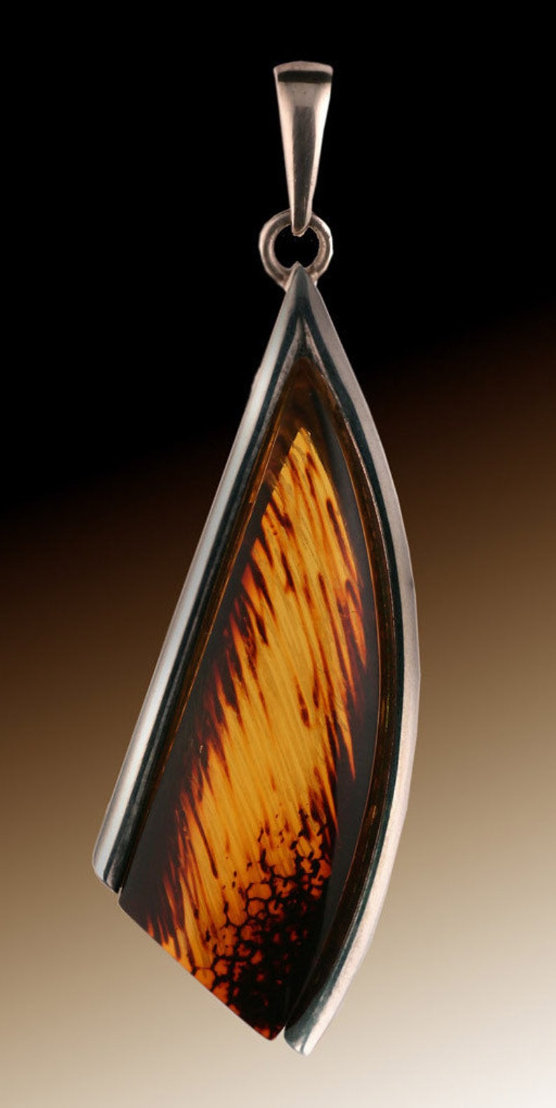 Amber Pendant...Sterling Silver surrounds 2 sides of this stunning piece of Amber jewelry