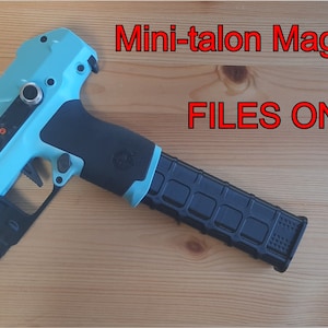 May include: A teal blue and black pistol with a black magazine. The text "Mini-talon Magsleeves FILES ONLY" is visible in the image.