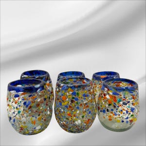 May include: Set of six colourful glass tumblers with a blue rim and speckled design. The glasses are made from recycled glass and are ideal for serving drinks.
