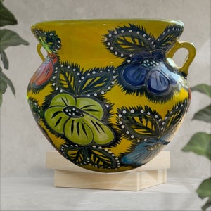 Talavera Planter medium multicolored with flower painted on the outside.