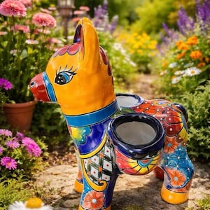 May include: A ceramic donkey-shaped planter featuring vibrant hand-painted patterns in orange, blue, red, and yellow. The donkey has two circular openings on its back for plants, with detailed floral and geometric motifs covering its entire body.